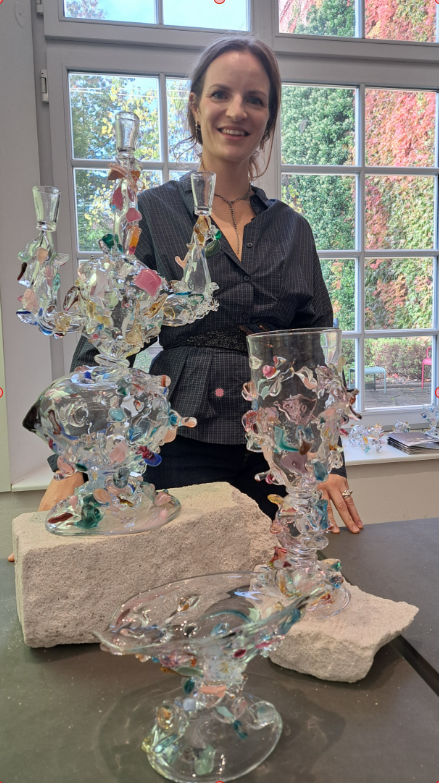 Glasdesignerin Laura Laerke Nielsen vor ihren Exponaten aus wiederverwendetem Glas auf der GRASSIMESSE 2026 in Leipzig.